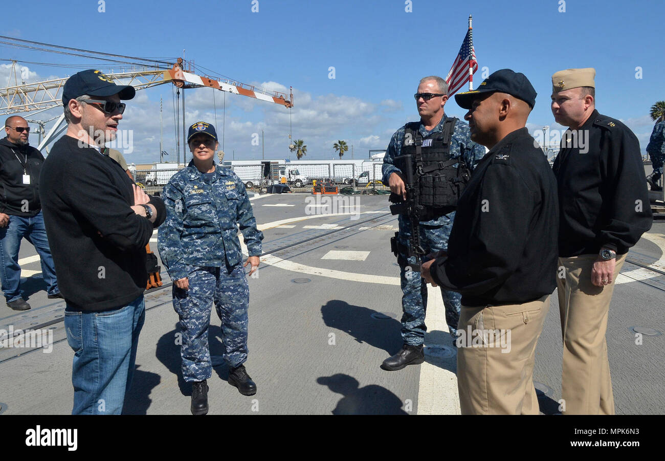 170323-N-IE405-055 SAN DIEGO (March 23, 2017) Naval Base San Diego Commanding Officer Capt. Roy Love, right, USS Sterett (DDG 104) Commanding Officer Cmdr. Claudine Caluori,left, and Naval Base San Diego Command Master Chief Matt Ruane discuss the filming of the television show 'The Last Ship' with actor Adam Baldwin, center, and the production crew on board the USS Sterett. (U.S. Navy photo by Mass Communication Specialist 2nd Class Indra Bosko/Released) Stock Photo