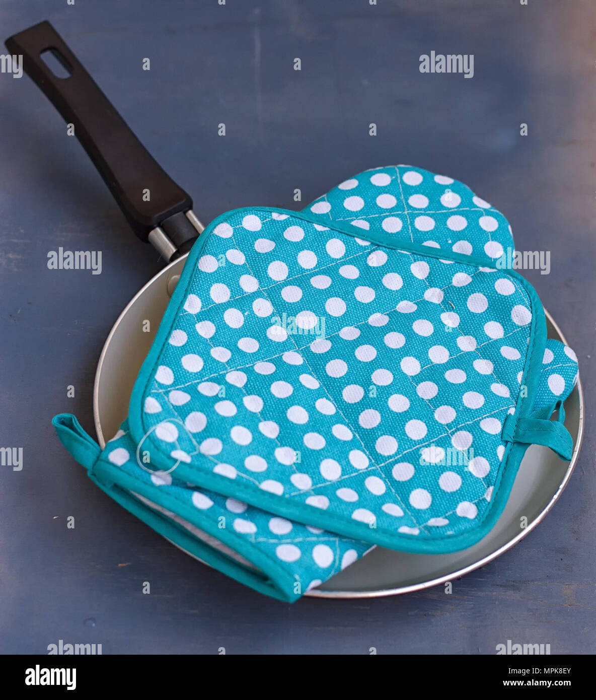 Oven mitt or potholder on the wooden background. Stock Photo
