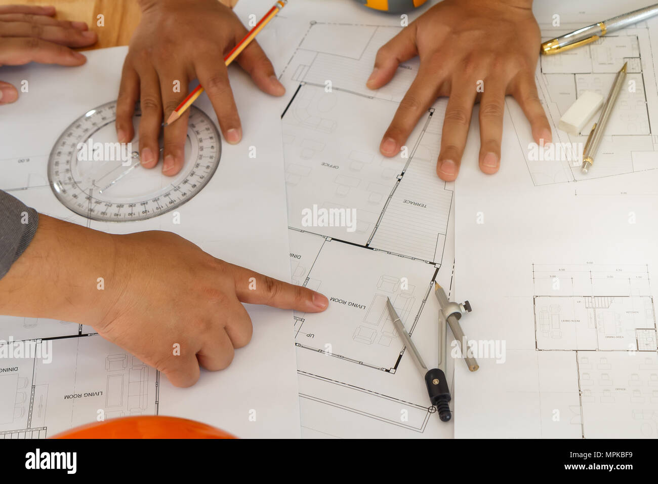 Architect or engineer working on blueprint, architectural concept. Engineer discussing with Architect team meeting and discussing project plan.Enginee Stock Photo