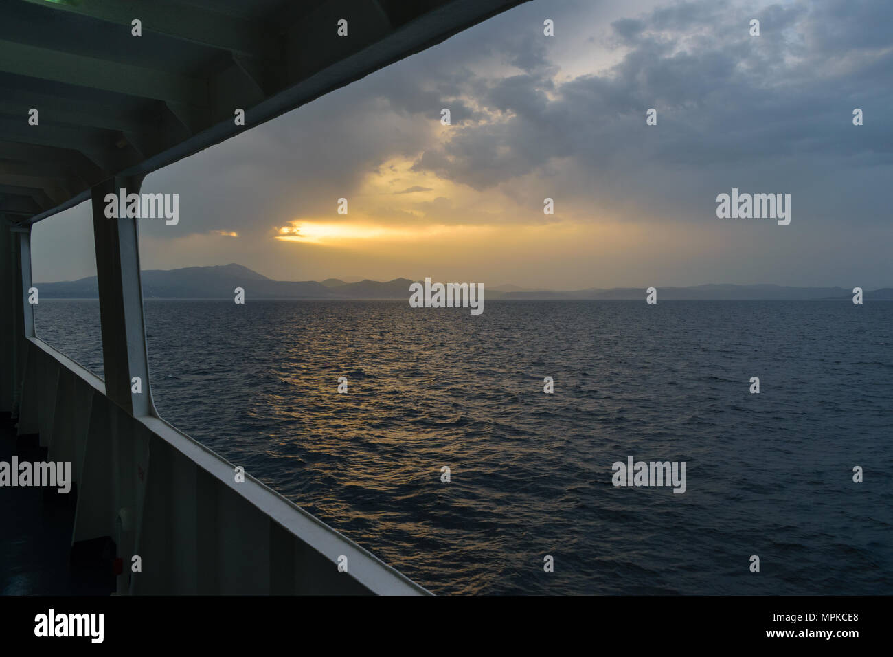 Sunset sunlight breaking through cloud seascape Stock Photo