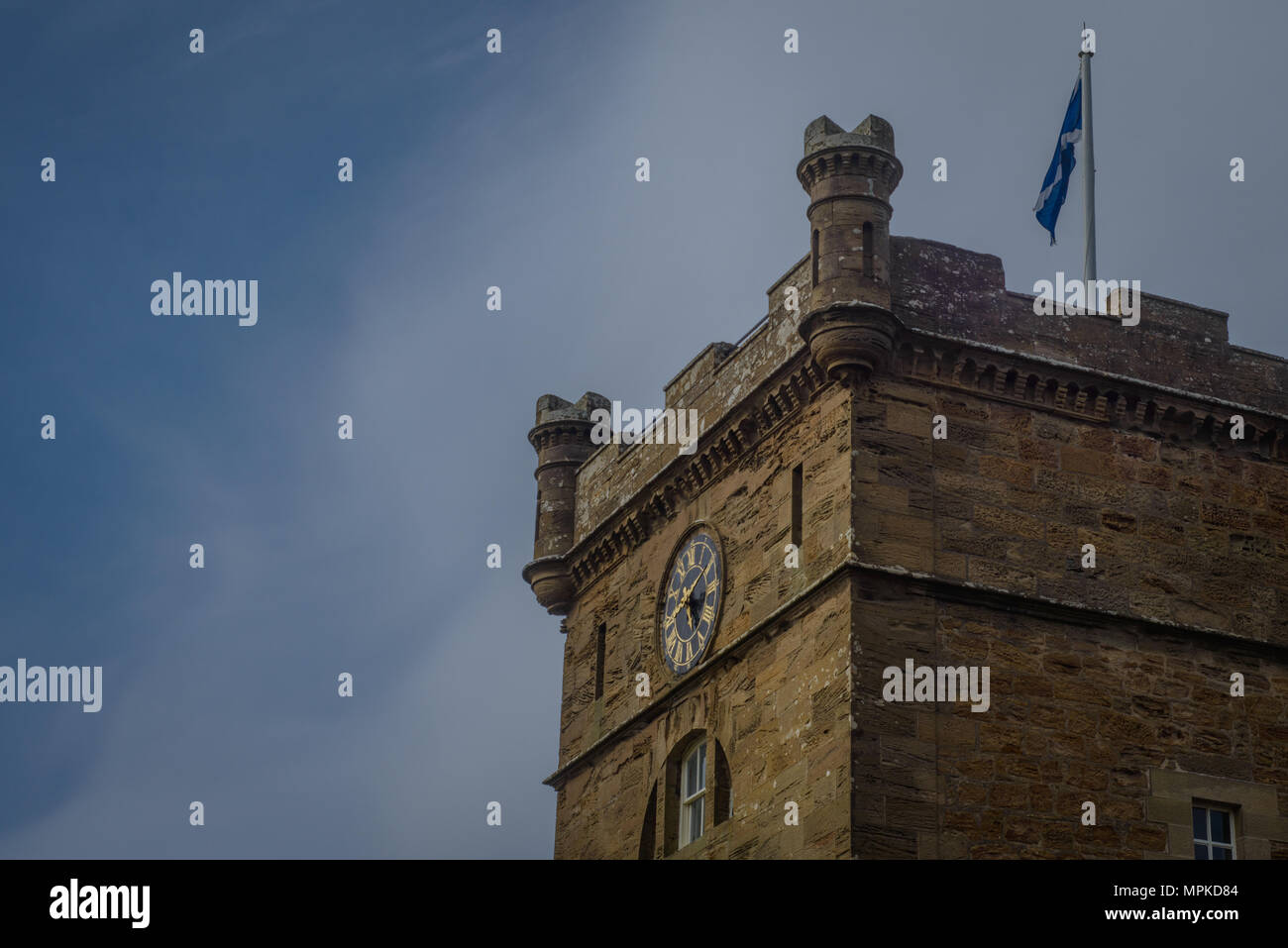 Clock Face Shows the Time on a Historic Tower With Scottish National Flag Above Stock Photo