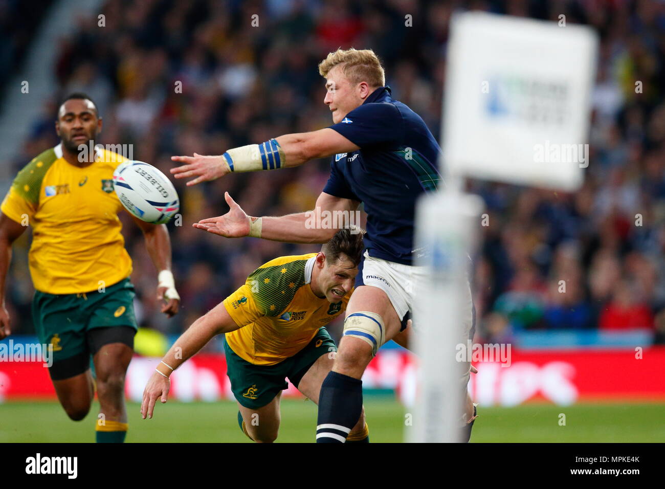 Dave Denton feeds the ball down the wing just before getting caught buy Bernard Foley 1during the IRB RWC 2015 Quarter Final match between Australia v Scotland at Twickenham Stadium. London, England. 18 October 2015 --- Image by © Paul Cunningham Stock Photo