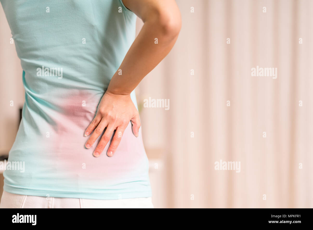 back pain at home. women suffer from backache. healthcare and medical concept Stock Photo