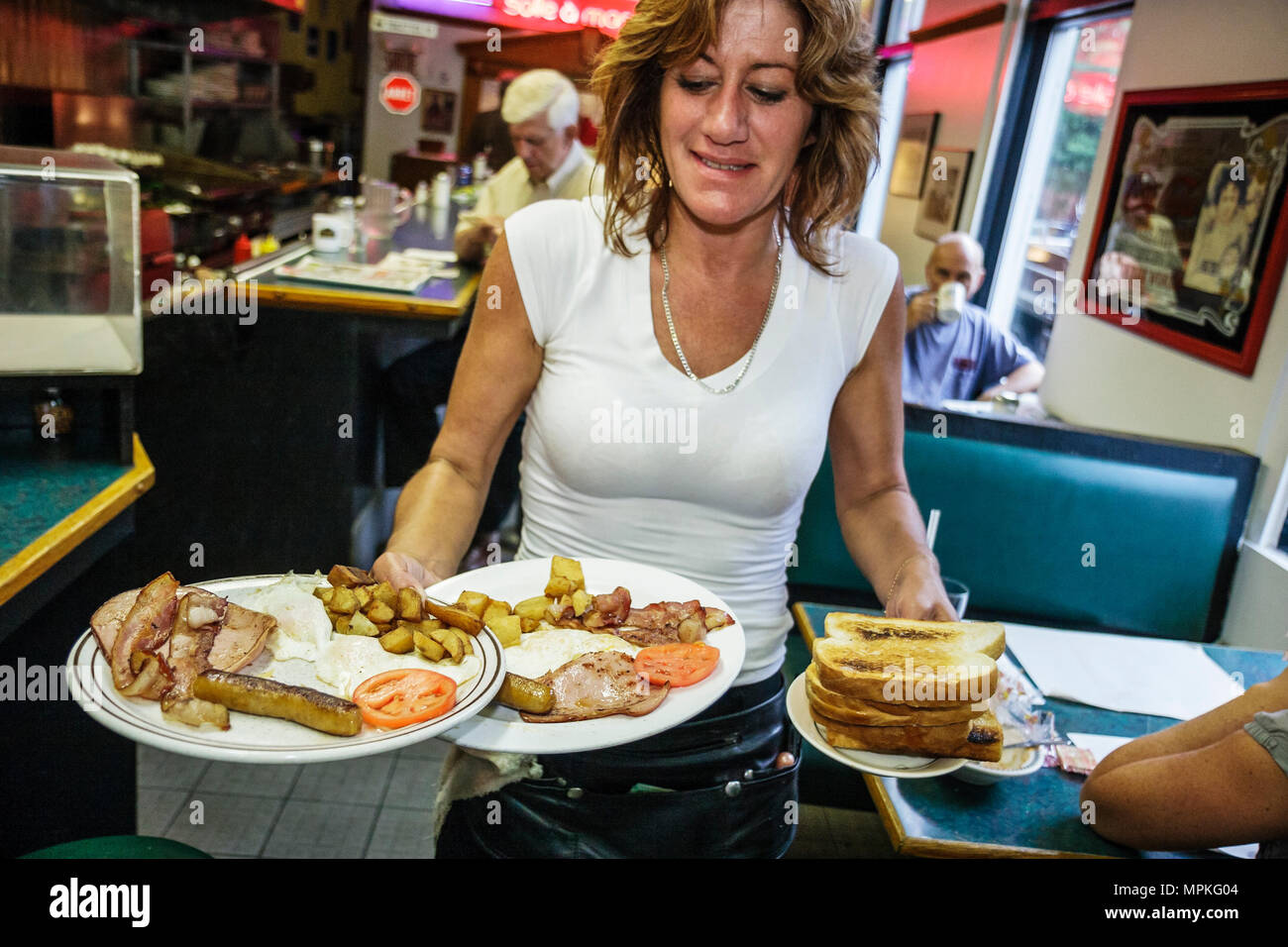 Waitress serves breakfast plates hires stock photography and images