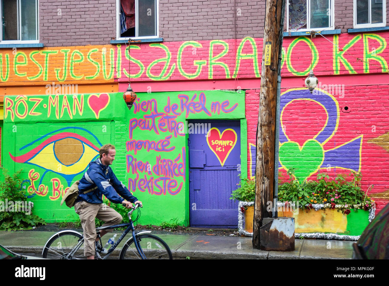 Montreal Canada,Quebec Province,Saint Catherine Street,gay,Le Village,painted walls,Hindu influenced,New Age,man men male,bicycle,bicycling,riding,bik Stock Photo