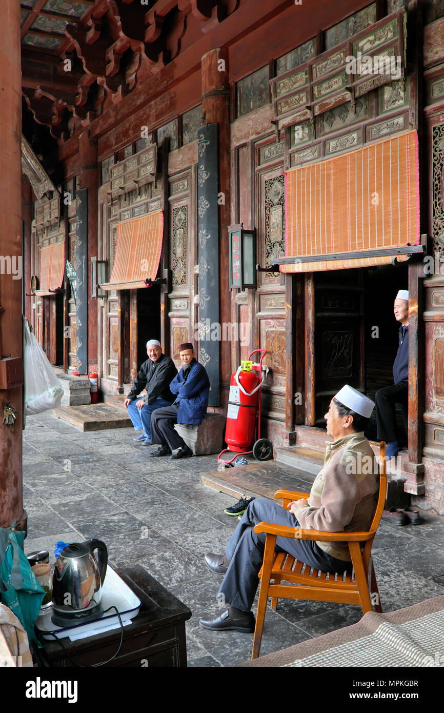 Custodian and friends, entrance to the prayer hall, Great Mosque of Xi'an, Xi'an, Shaanxi Province, China Stock Photo