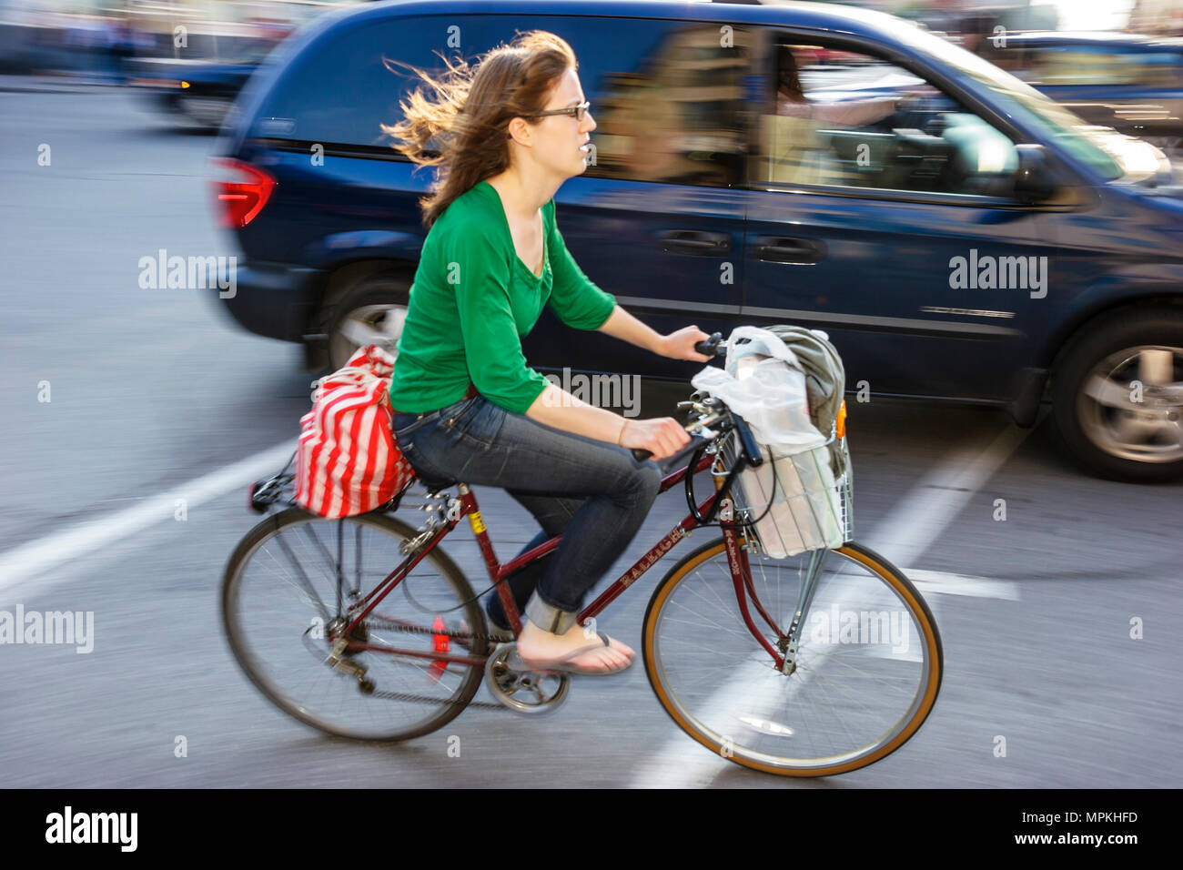 Montreal Canada,Quebec Province,Avenue du Parc,woman female pedals bicycle,bicycling,riding,biking,rider,bike,cars,traffic,Canada070705166 Stock Photo