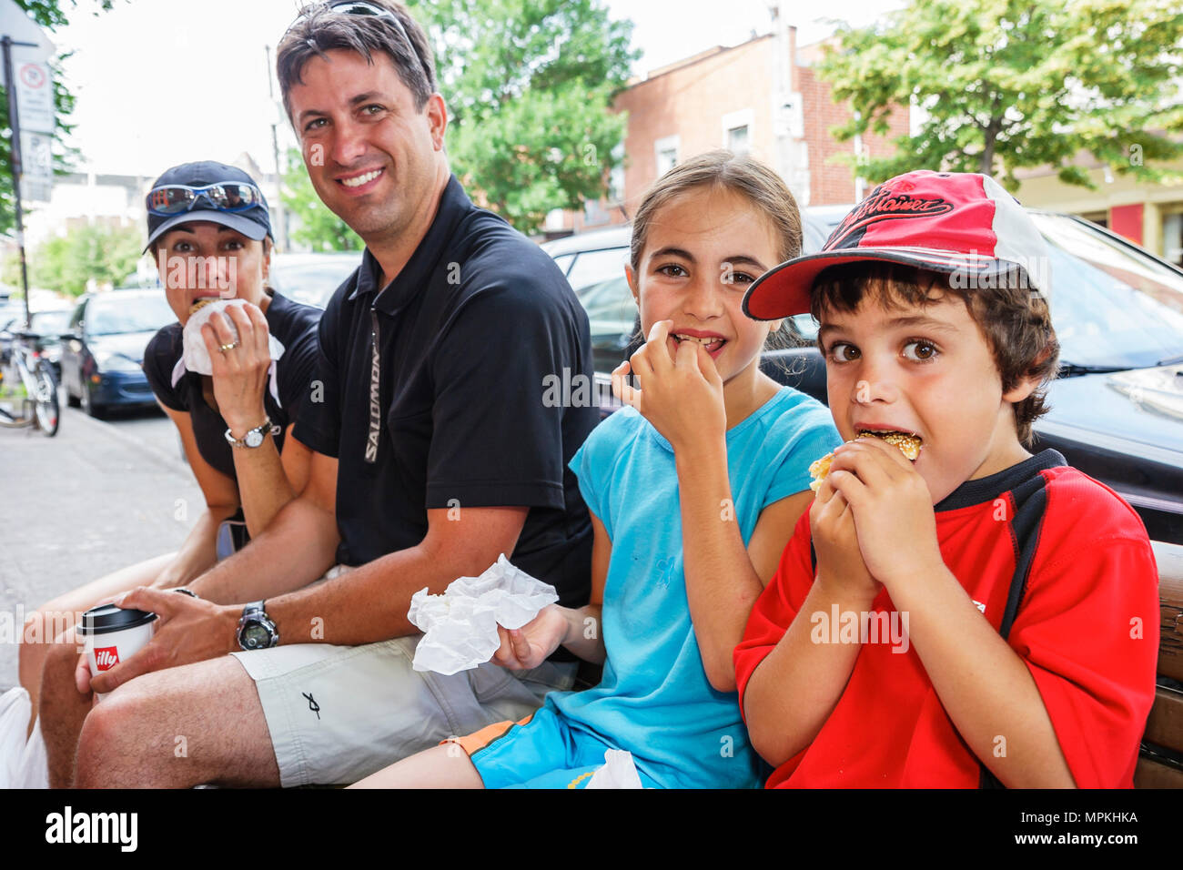 Canada,Canadian,Quebec Province,French language,bilingual speaking,Montreal,Avenue Fairmount,family families parent parents child children,eating bage Stock Photo