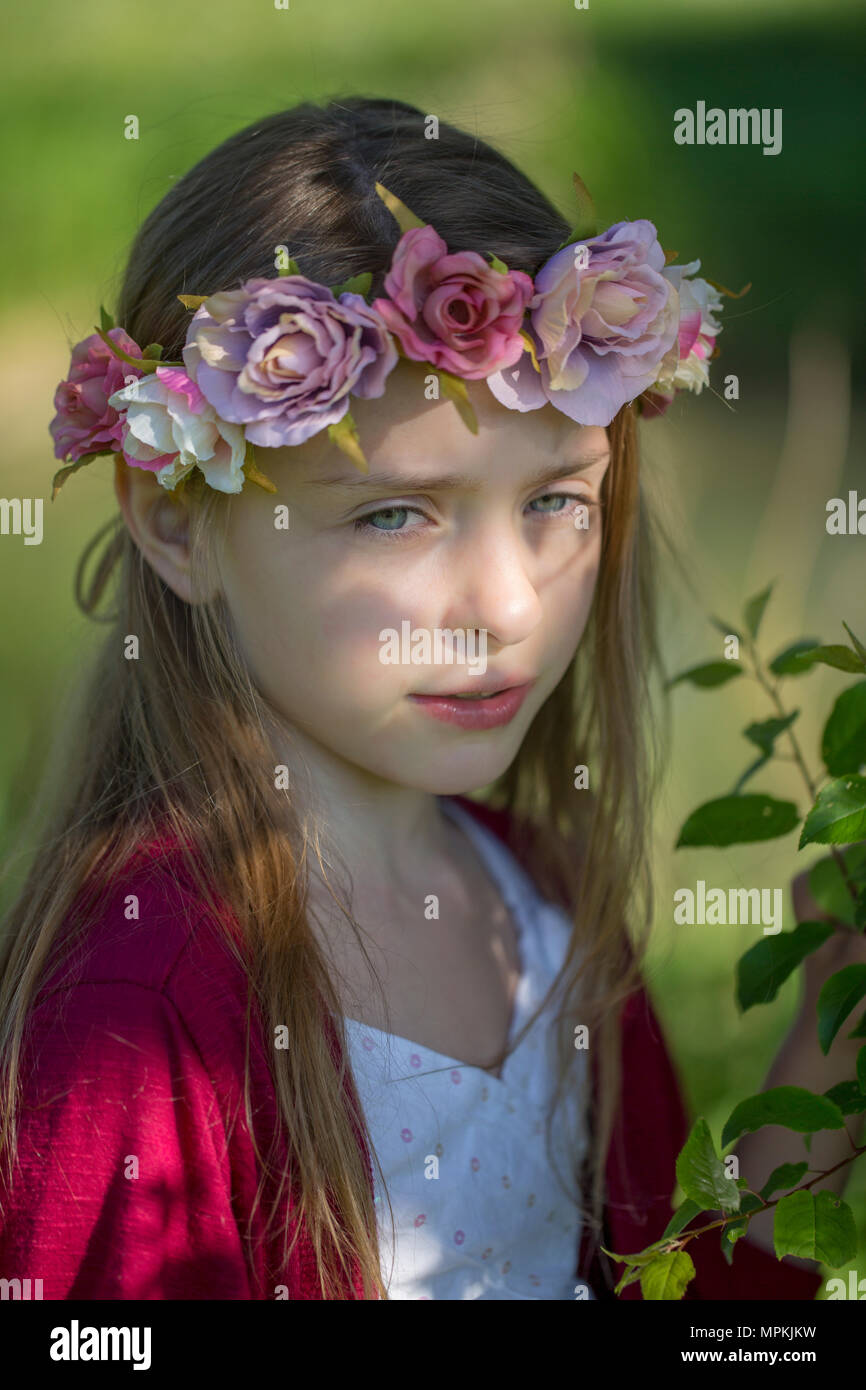 Portrait of daydreaming little girl wearing flowers Stock Photo - Alamy