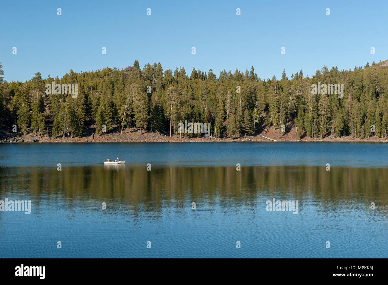 Two men in a boat on a lake with a fishing rod Stock Photo