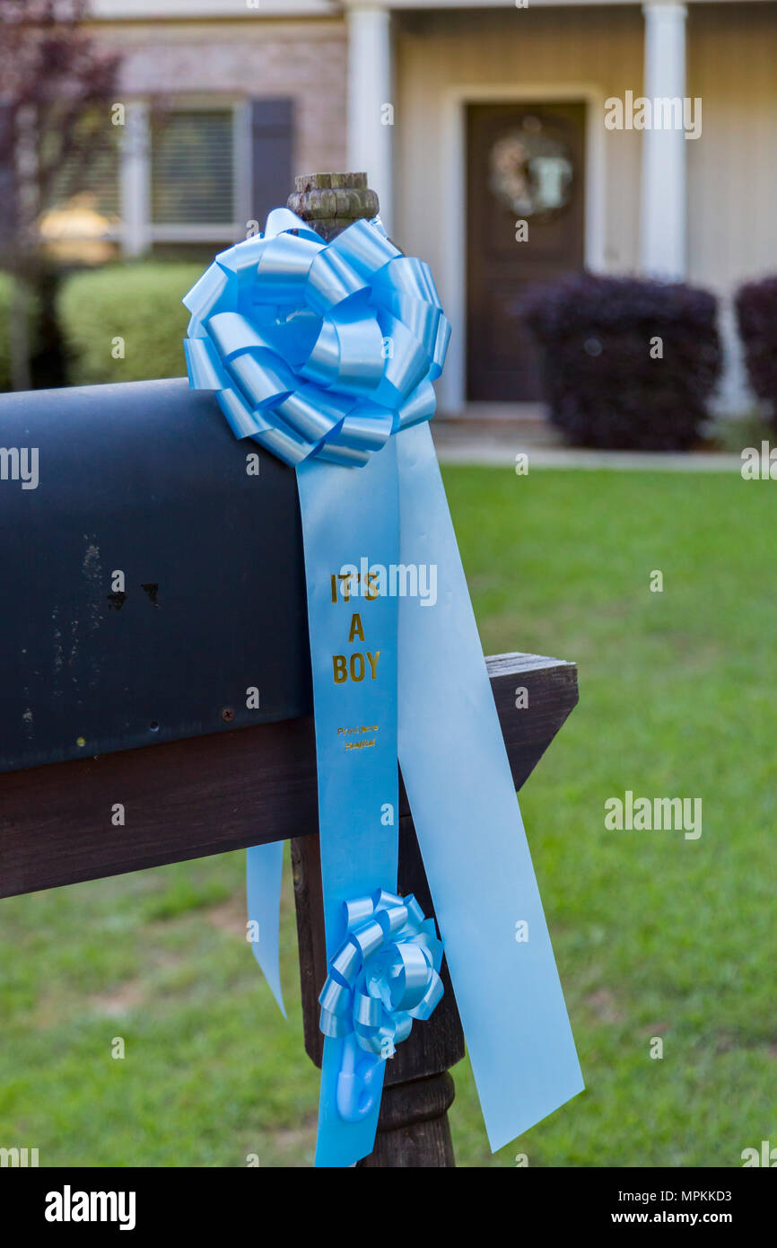 Blue ribbon on a mailbox in front of a house announces the arrival of a new baby boy in Mobile, Alabama Stock Photo