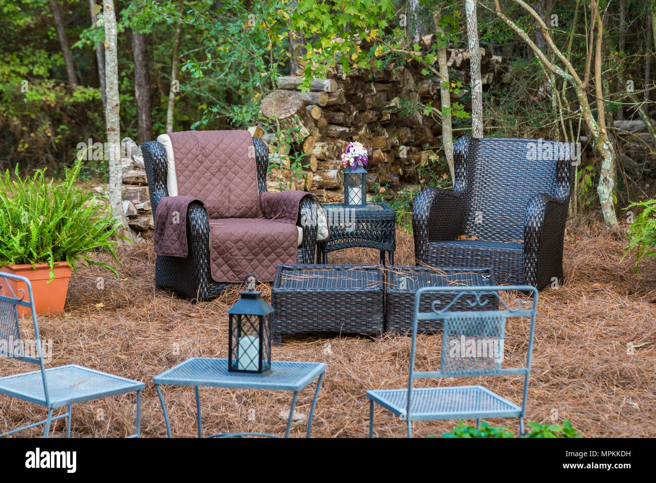Outdoor seating at the edge of a wooded area Stock Photo