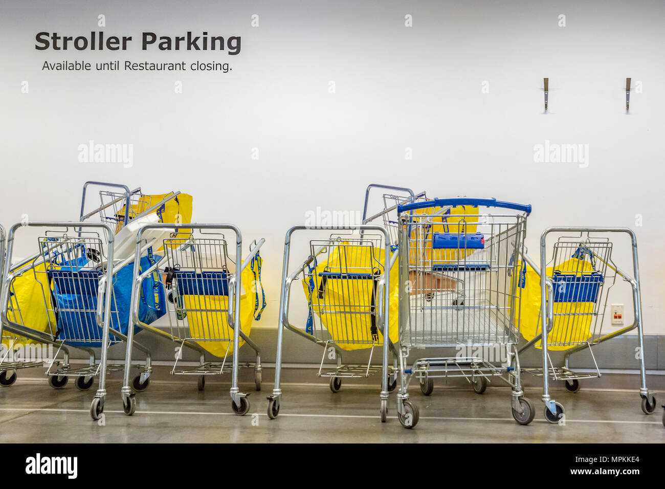 Shopping carts under a Stroller Parking sign inside an Ikea store in the US Stock Photo