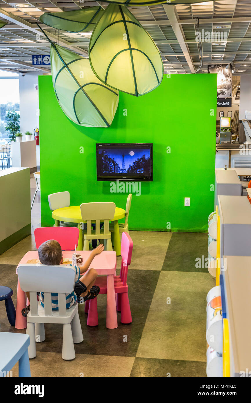 Child watching television in the restaurant of an Ikea store in the US Stock Photo