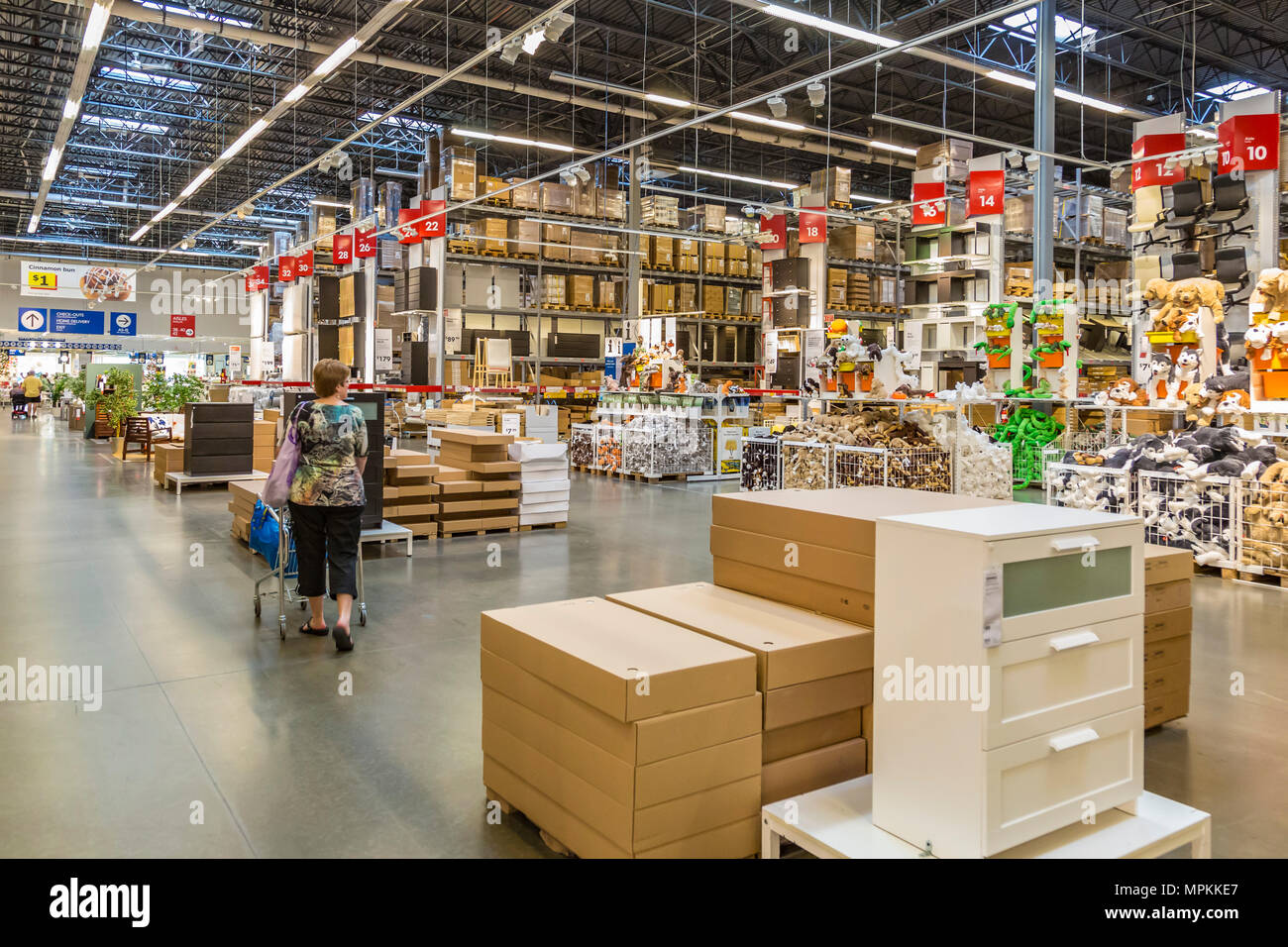 Female customer shopping inside the warehouse section of an Ikea store in the US Stock Photo