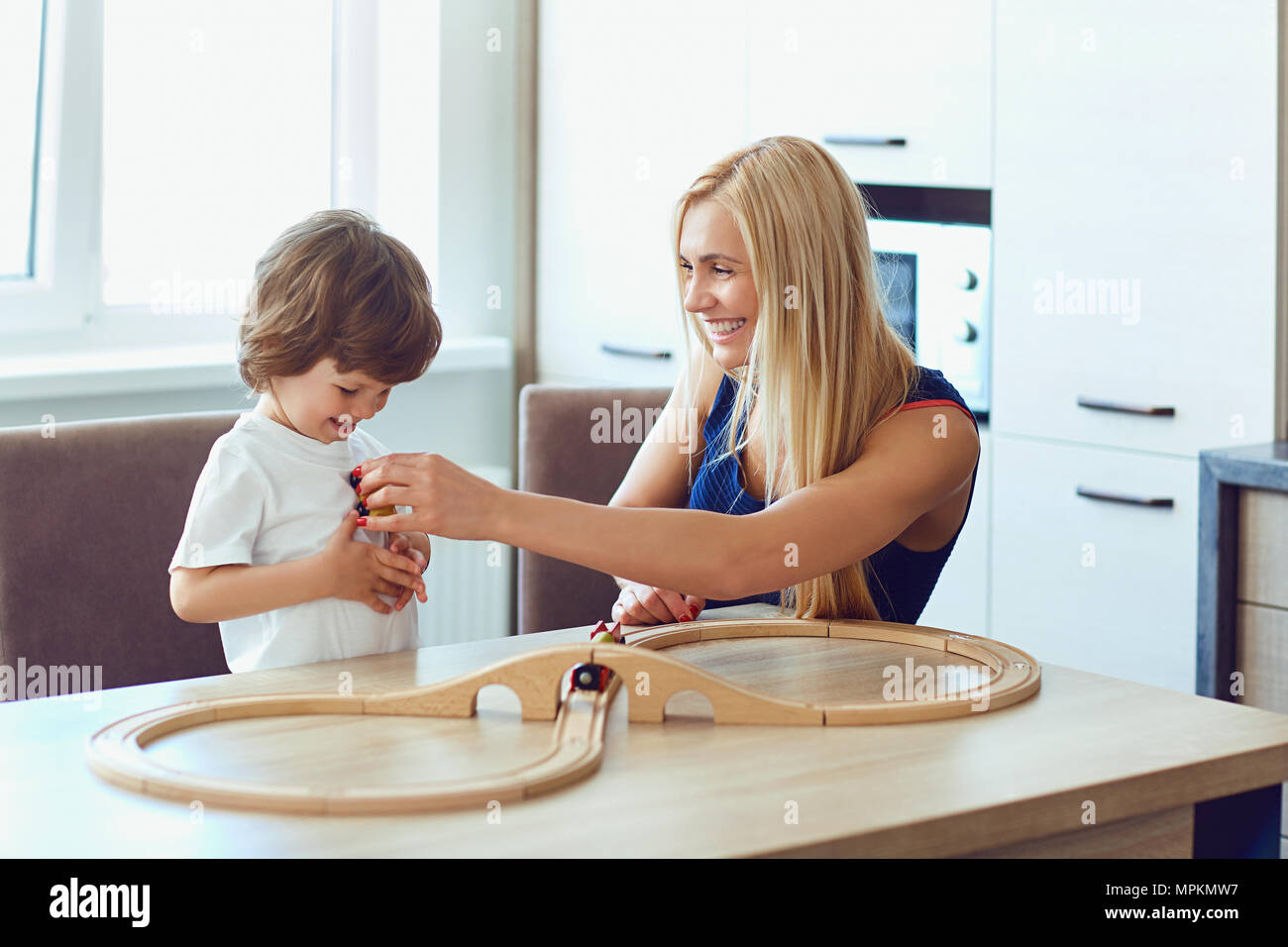 Mother and son play indoor board games.  Stock Photo