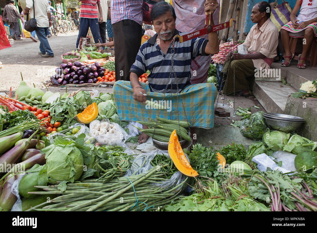 India, West Bengal, Kolkata, Vendor in the vegetable market in the