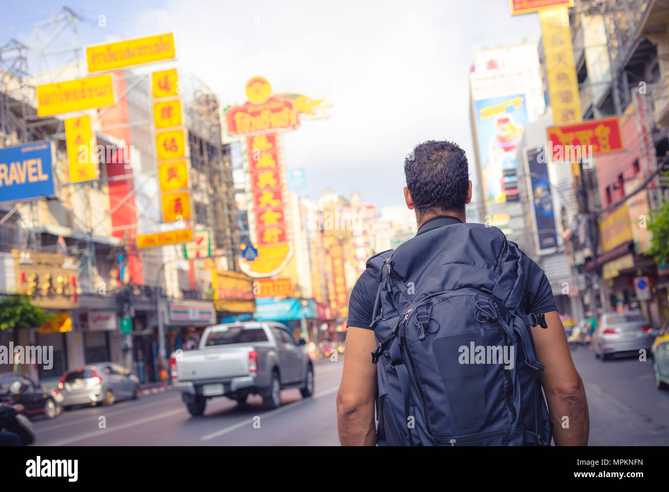 men backpacker looking at the famous place of Yaowarat road in Chinatown Bangkok during day, Thailand , Southeast asia . Stock Photo