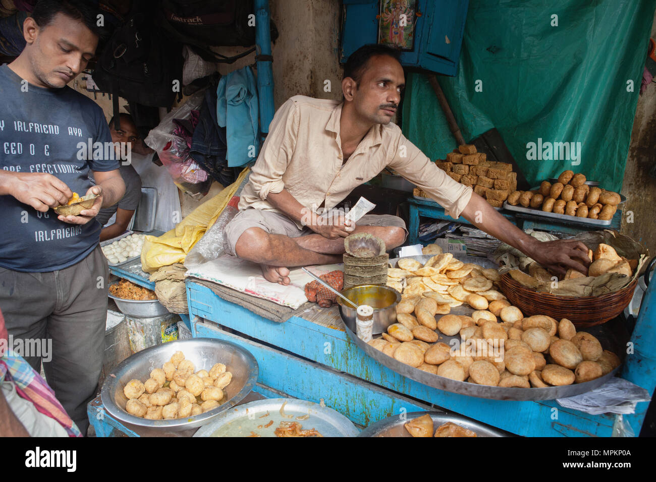 India, West Bengal, Kolkata, A vendor selling snack food including samosas, kachori, and pani puri. Stock Photo