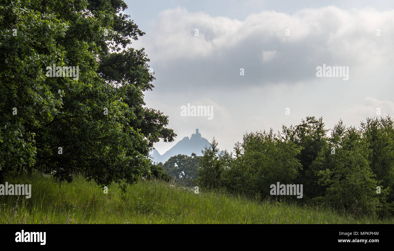 Panoramic view of Bezdez castle in the Czech Republic. In the foreground there are trees, in the background is a hill with castle and there are a whit Stock Photo