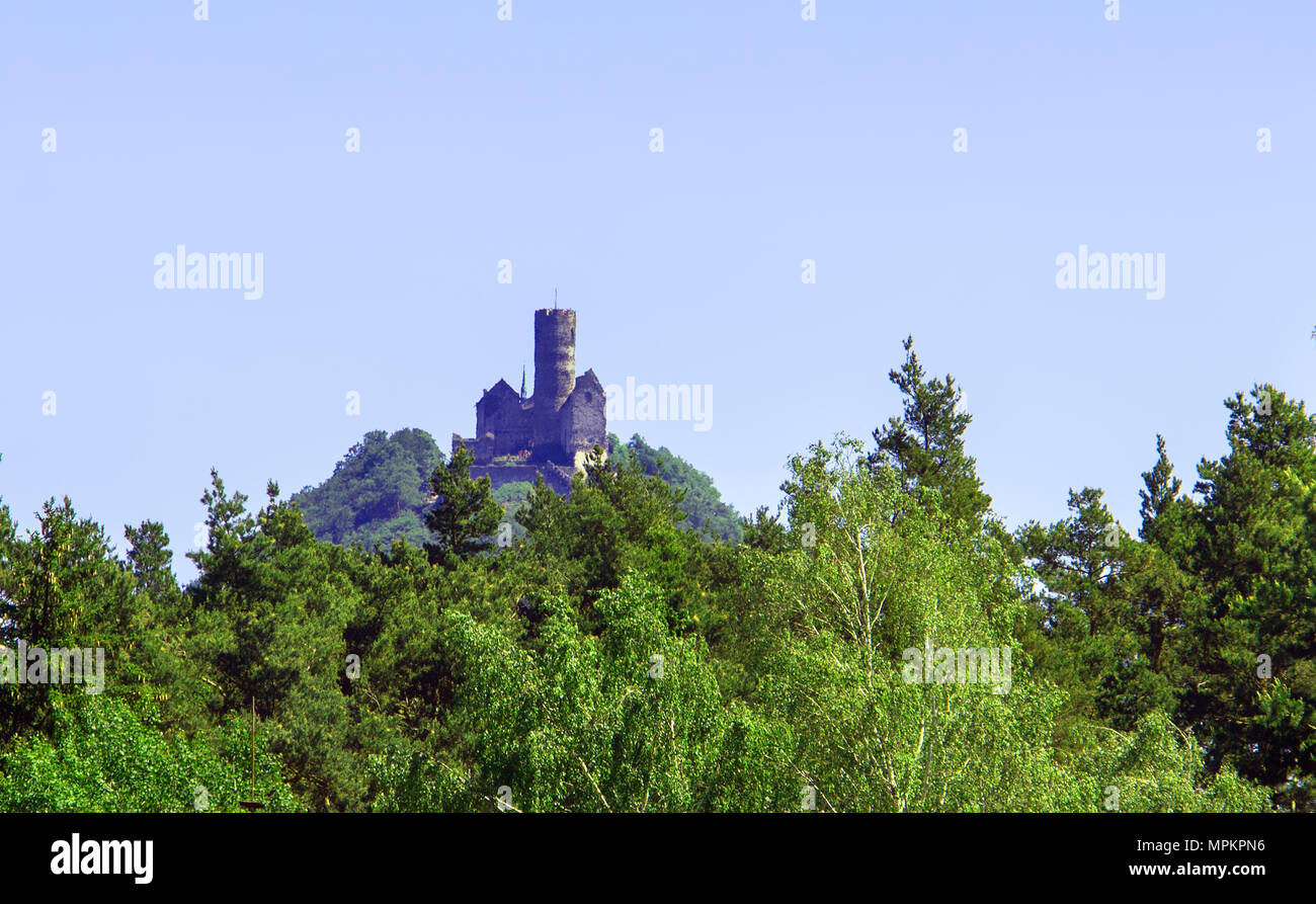 Panoramic view of Bezdez castle in the Czech Republic. In the foreground there are trees, in the background is a hill. Stock Photo