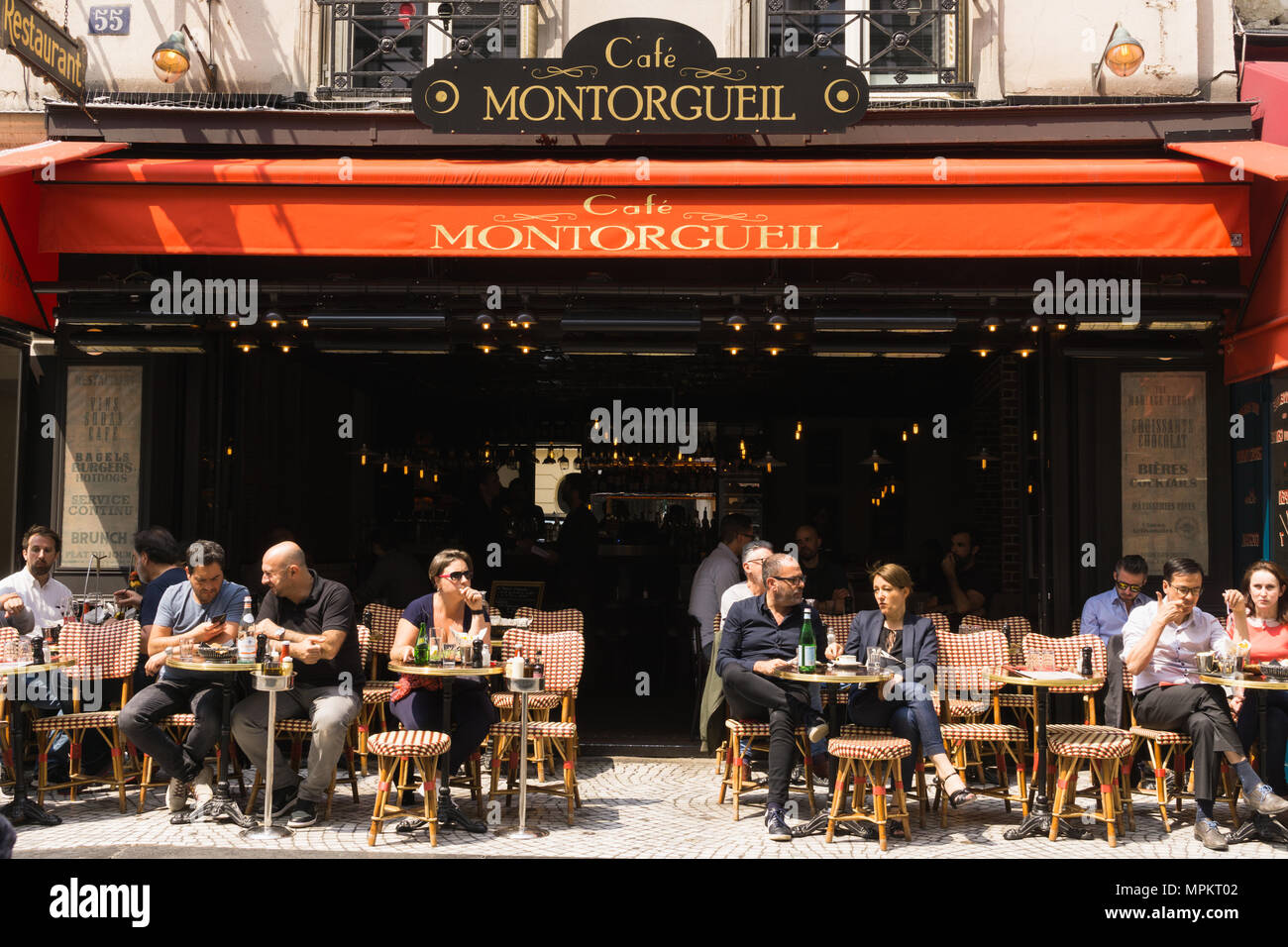 Patrons chatting and people-spotting at cafe Montorgueil on Rue Montorgueil in Paris, France. Stock Photo