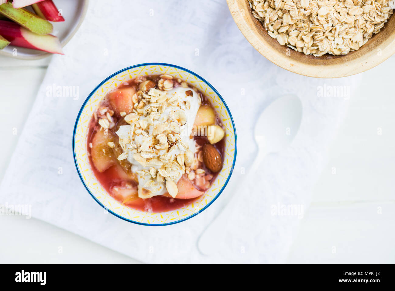 Homemade rhubarb and apple compote with coconut yogurt and oatmeal, healthy detox snack Stock
