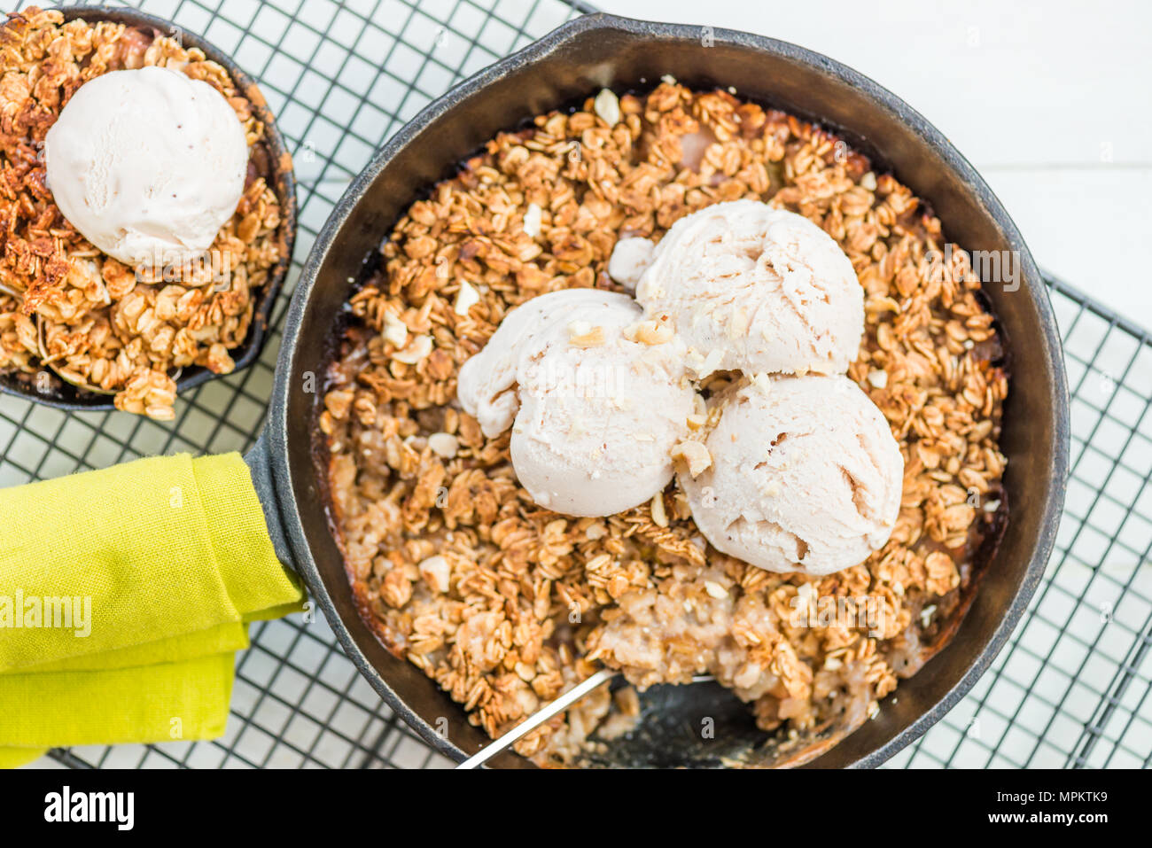 Homemade cooked rhubarb and apple crumble with oatmeal and vanilla ice