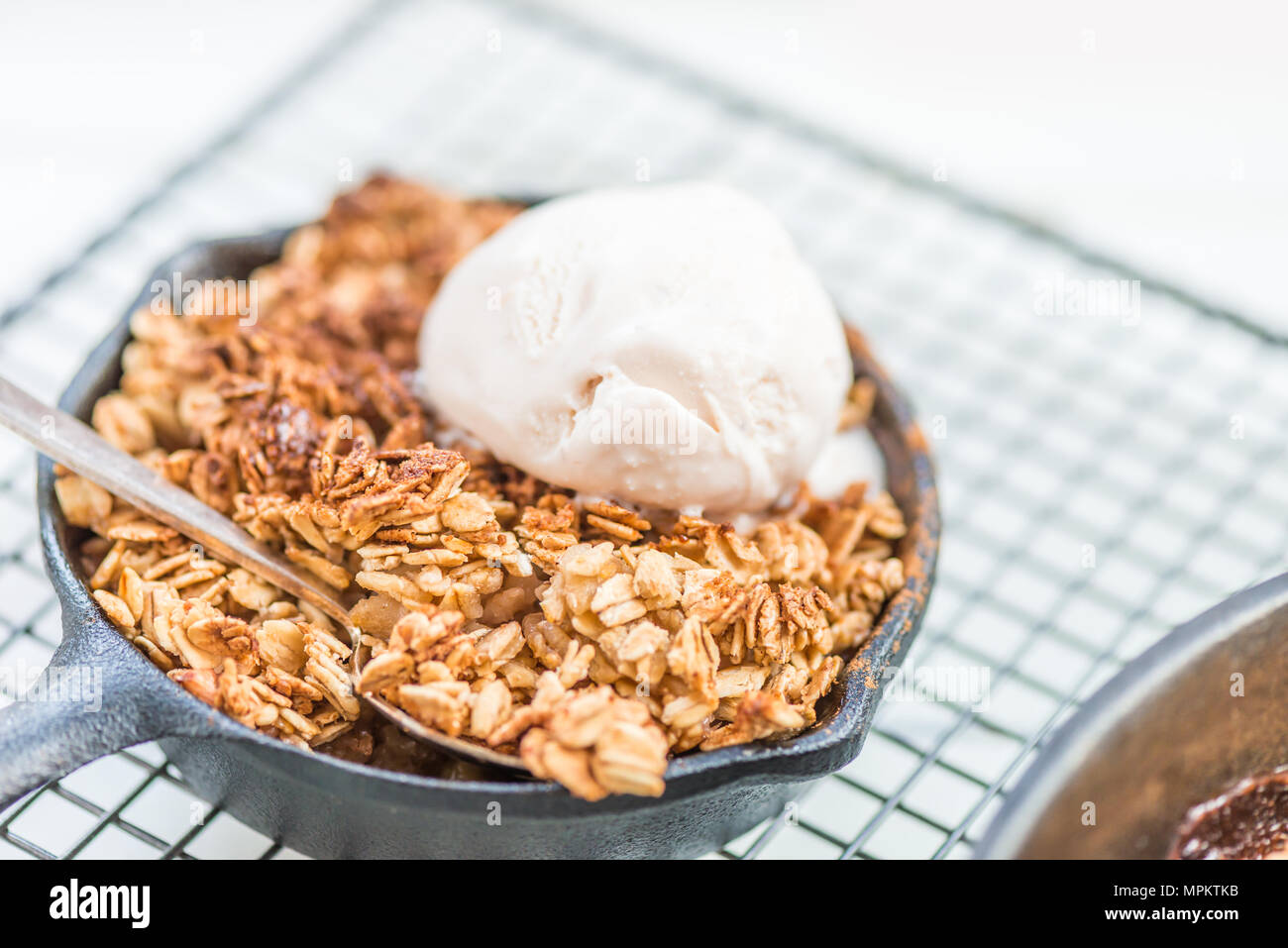 Homemade cooked rhubarb and apple crumble with oatmeal and vanilla ice
