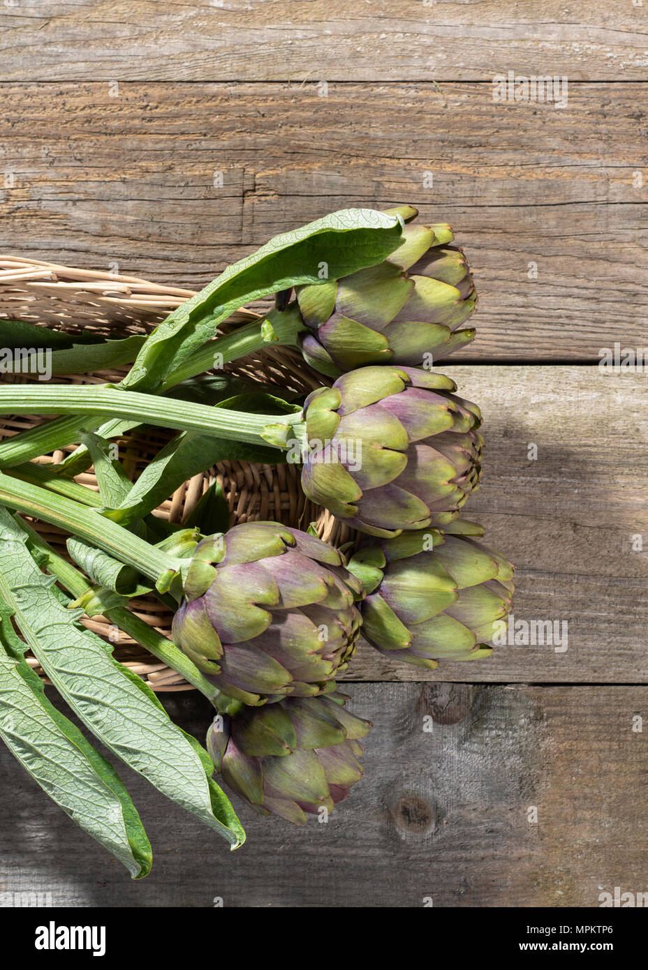 Artichoke vegetable natural look on wooden floor Stock Photo Alamy