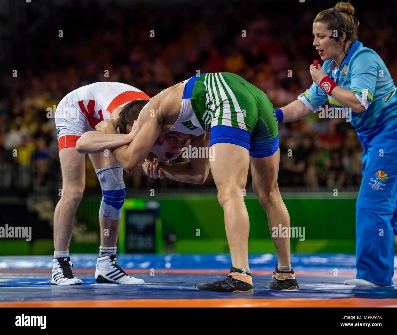 GOLD COAST, AUSTRALIA - APRIL 12: Muhammad Bilal of Pakistan v George Ramm of England competing in the men's 57kg Bronze Medal Freestyle match. Stock Photo