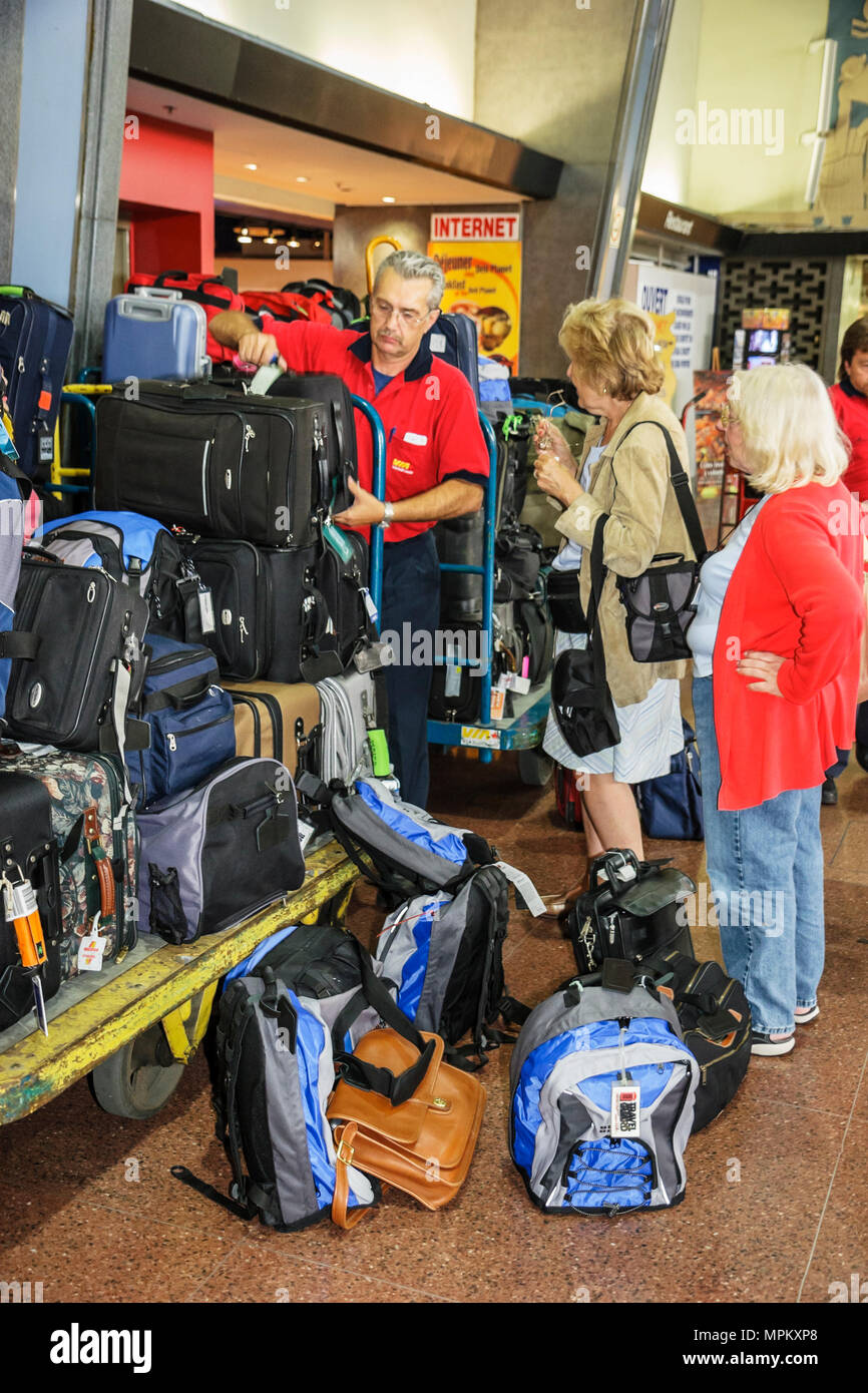 Canada,Canadian,Quebec Province,French language,bilingual speaking,Montreal,Gare Centrale,Central Train Station,schedule,ticketing,porter,luggage,suit Stock Photo