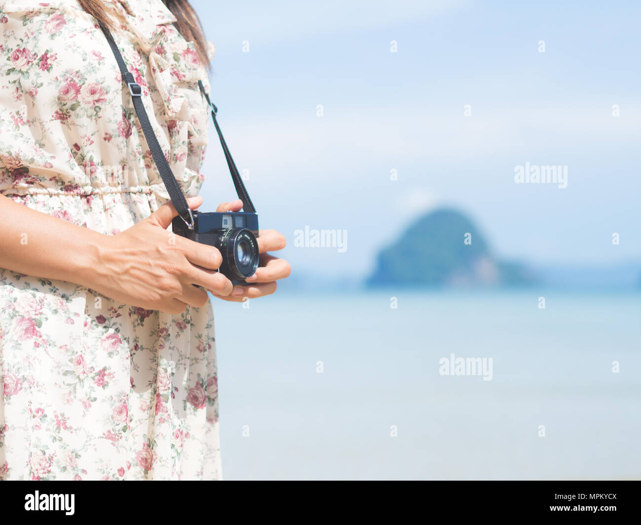 woman holding camera and walk on the beach seaside Stock Photo - Alamy