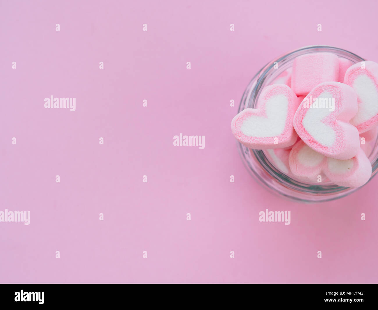 Pink fluffy heart shaped marshmallows candy background. Stock Photo by  ©galiyahassan 340052556