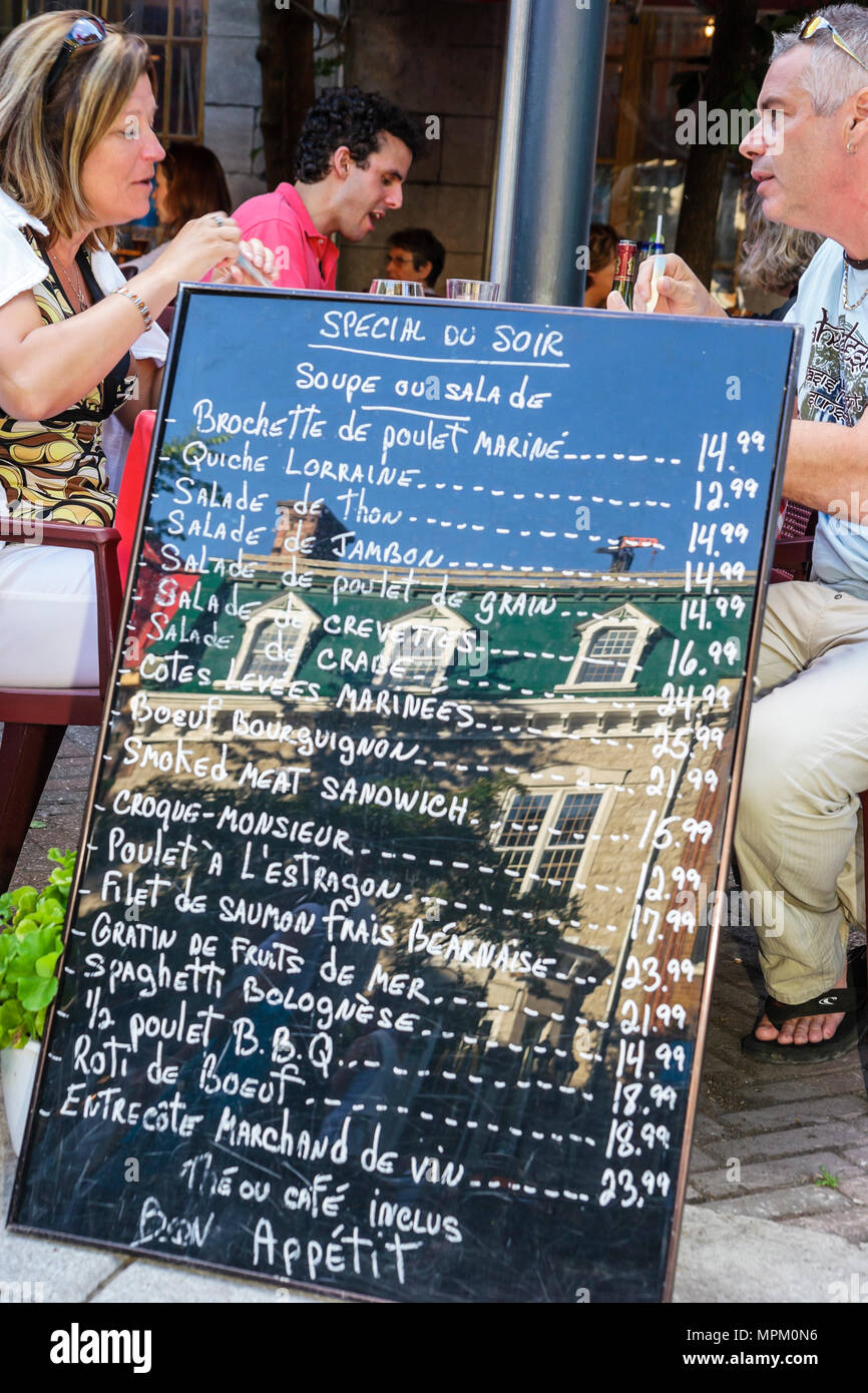 Quebec Canada,Grande Allee,al fresco sidewalk outside tables,dining,eating,menu,prices,couple,adult,adults,Canada070712198 Stock Photo