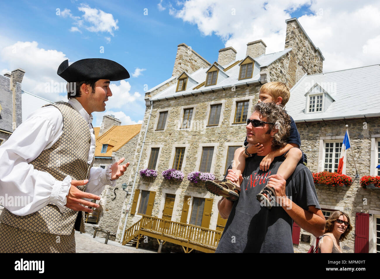 Quebec Canada,Lower Town,Place Royal,reenactor,reenact,role play,act,costume,actor,colonial costume,father,parent parents,son,historic buildings,city Stock Photo
