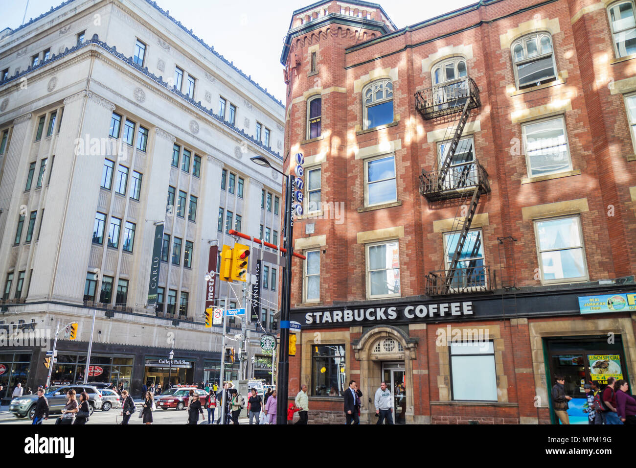 Toronto Canada,College Street,Yonge Street,street scene,IOOF Hall,historic building,Gothic Revival,cafe,Starbucks Coffee,barista,sign,College Park,sho Stock Photo