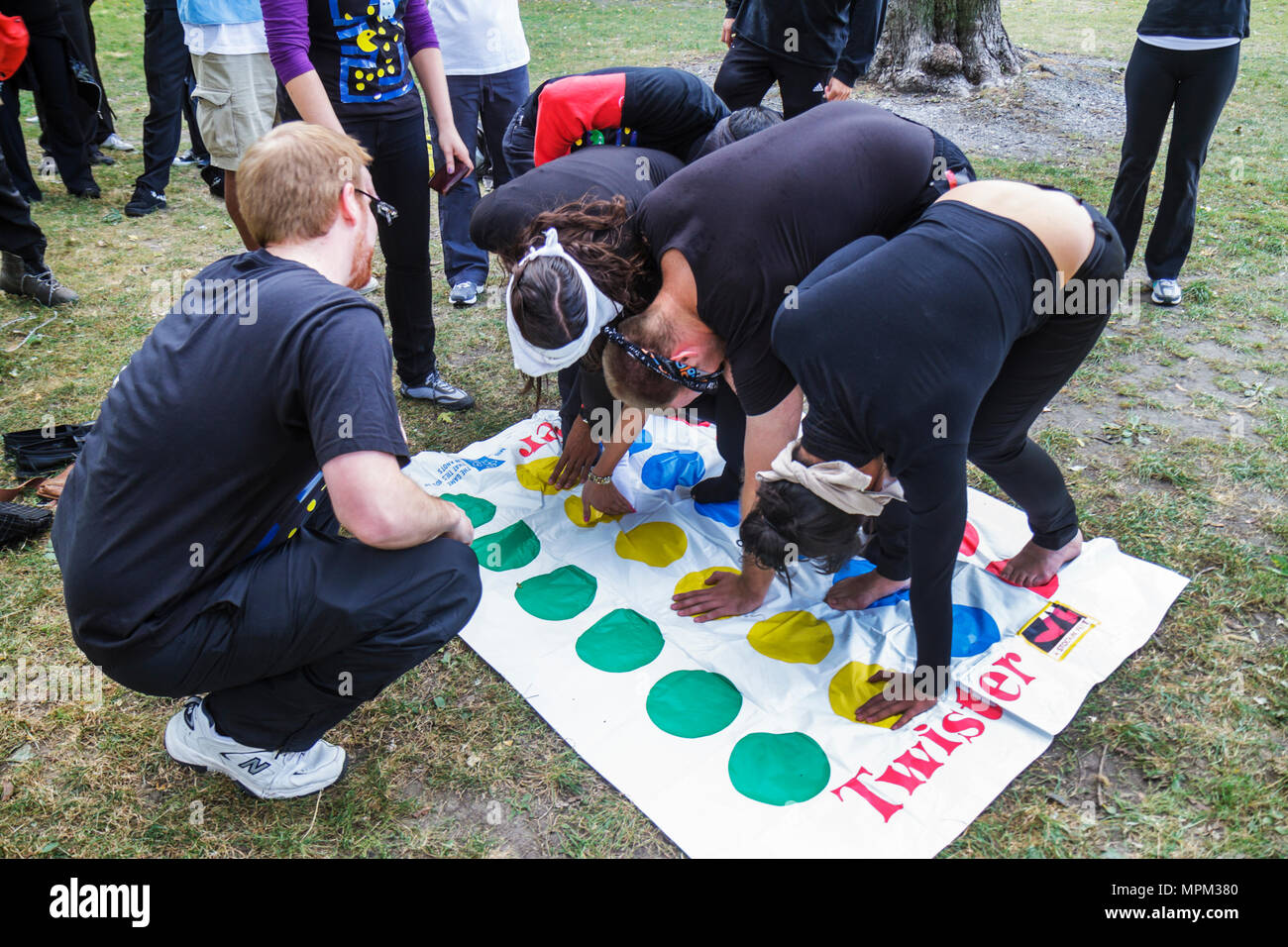 Toronto Canada,King Street East,Saint James Park,local,Amazing Race,contestants,lawn,Twister,Hasbro game,mat,flexibility,physical activity,adult adult Stock Photo
