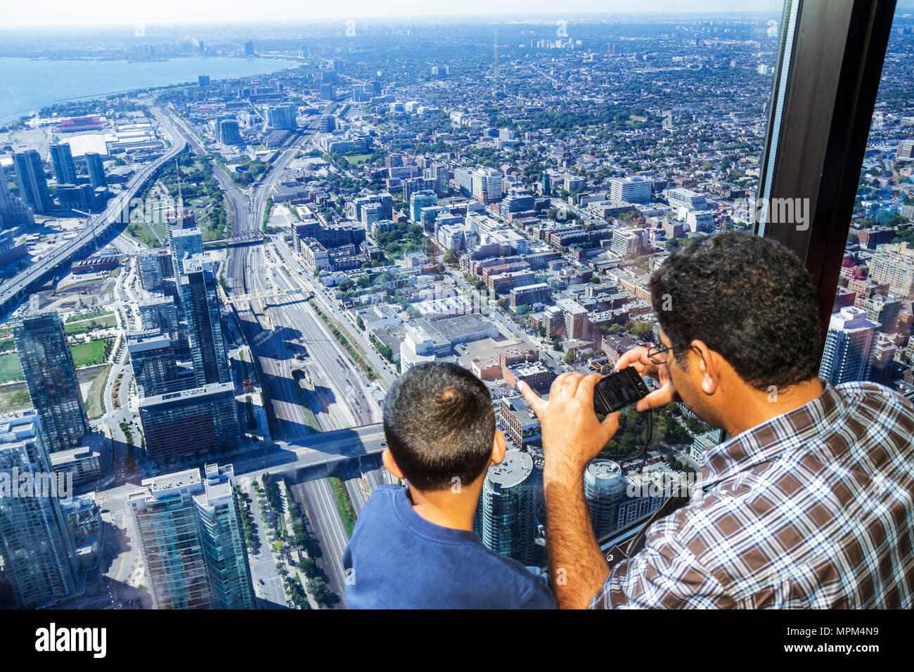 Toronto Canada,CN Tower observation main deck level,window aerial ovehead from above view family boy father son Stock Photo