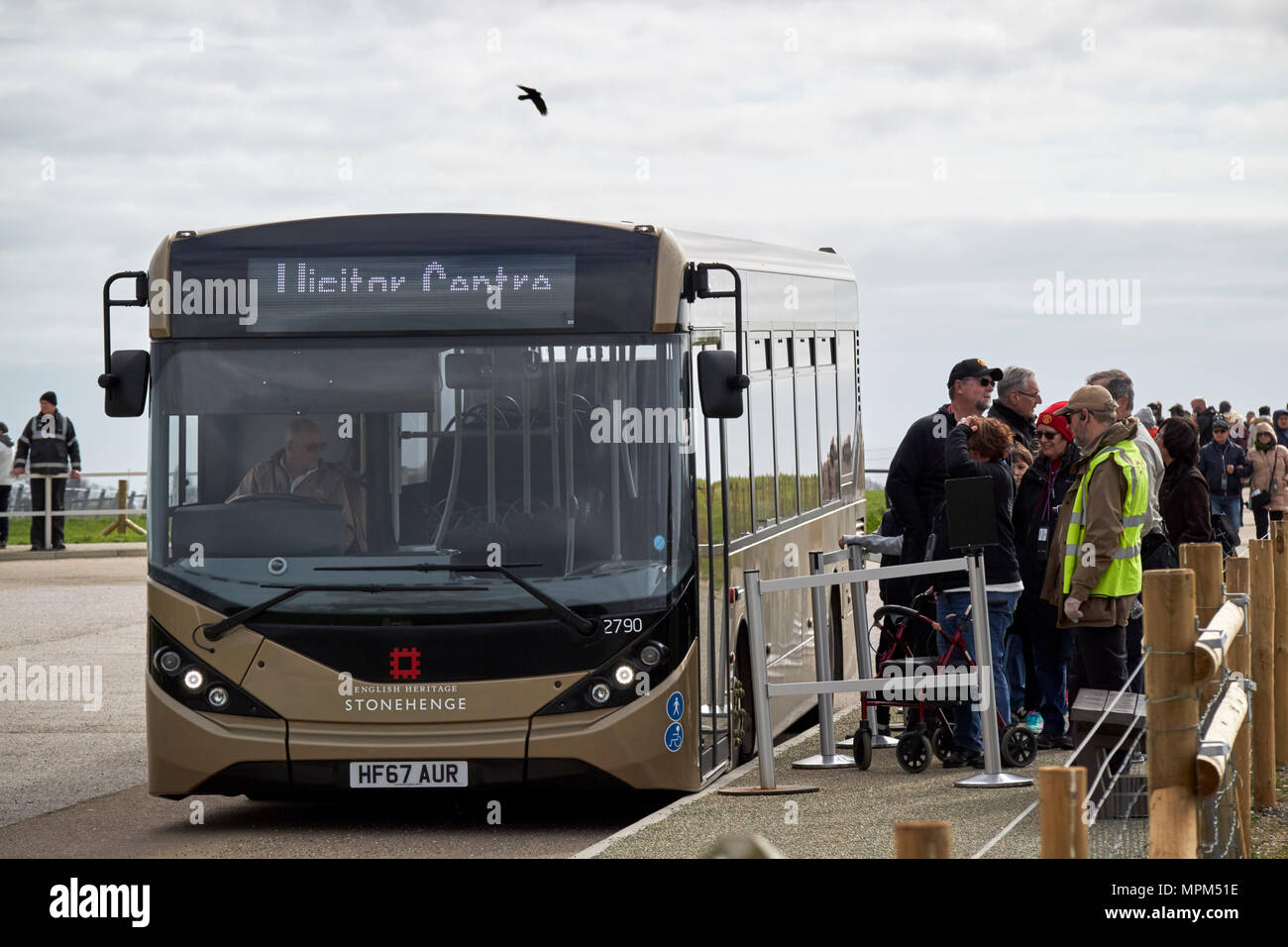 tourists queue for the shuttle bus between the stones and visitors centre at stonehenge wiltshire england uk Stock Photo