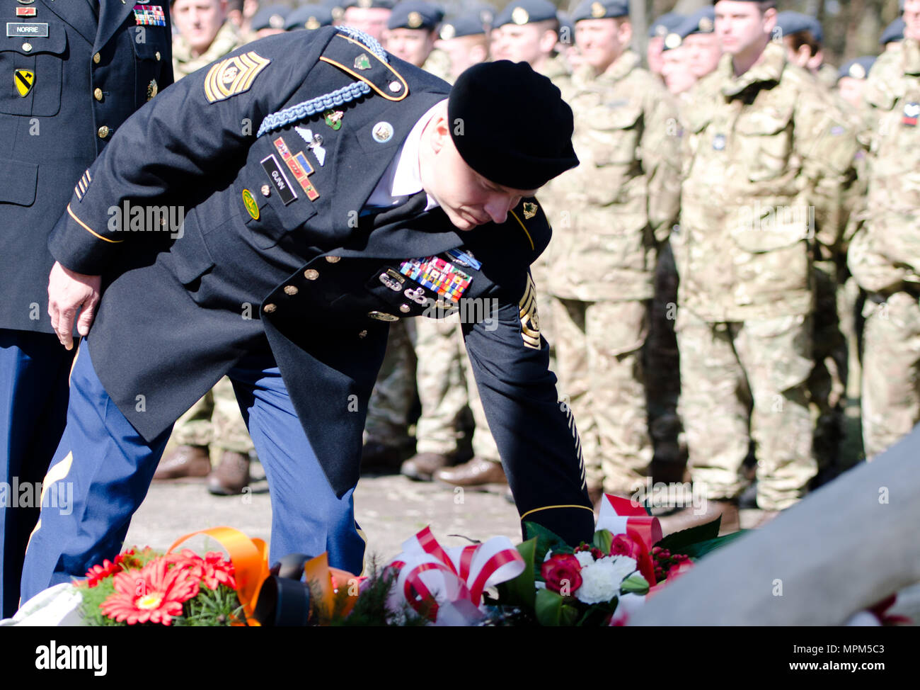 Command Sgt. Maj. Christopher D. Gunn from 3rd ABCT, 4th ID, lays a wreath in honor of those who were held as POWs at camp Stalag Luft III during a commemoration ceremony March 24, 2017 at Zagan, Poland.  Members of 3rd ABCT, 4th ID participated in the two-day event to strengthen their relationships with their Polish Allies while participating in Operation Atlantic Resolve. (U.S. Army photo by Capt. John W. Strickland, 7th Mobile Public Affairs Detachment) Stock Photo