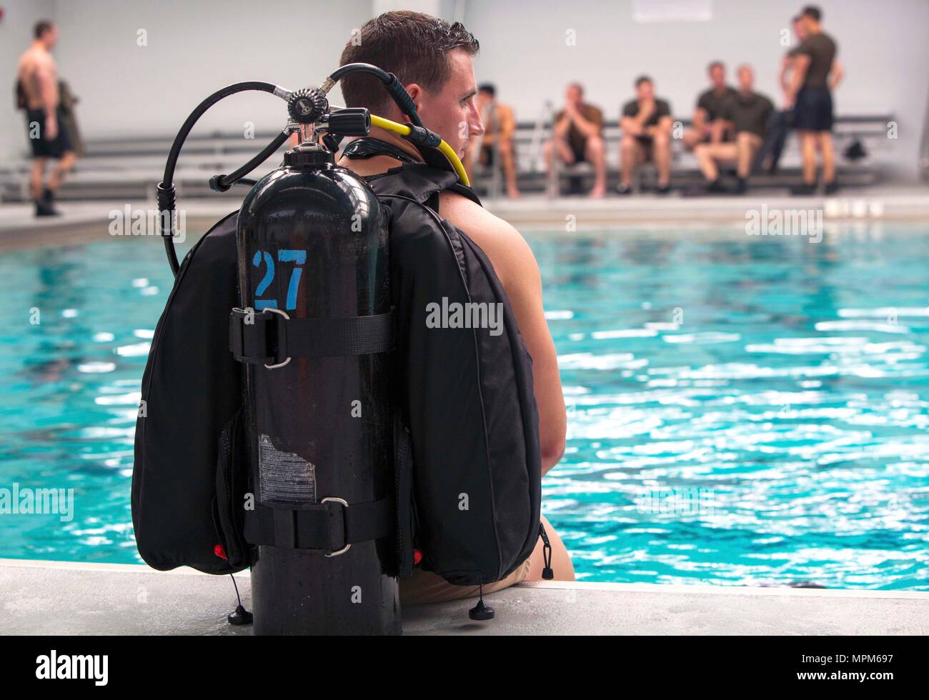 Sgt. Ryan Williams prepares to dive into the pool with a self-contained underwater breathing apparatus during a battalion training event at Camp Lejeune, N.C., March 23, 2017. The training helped Marines enhance their ability to operate in real-world scenarios with scuba gear. Williams is a reconnaissance Marine with 2nd Reconnaissance Battalion, 2nd Marine Division. (U.S. Marine Corps photo by Sgt. Clemente C. Garcia) Stock Photo