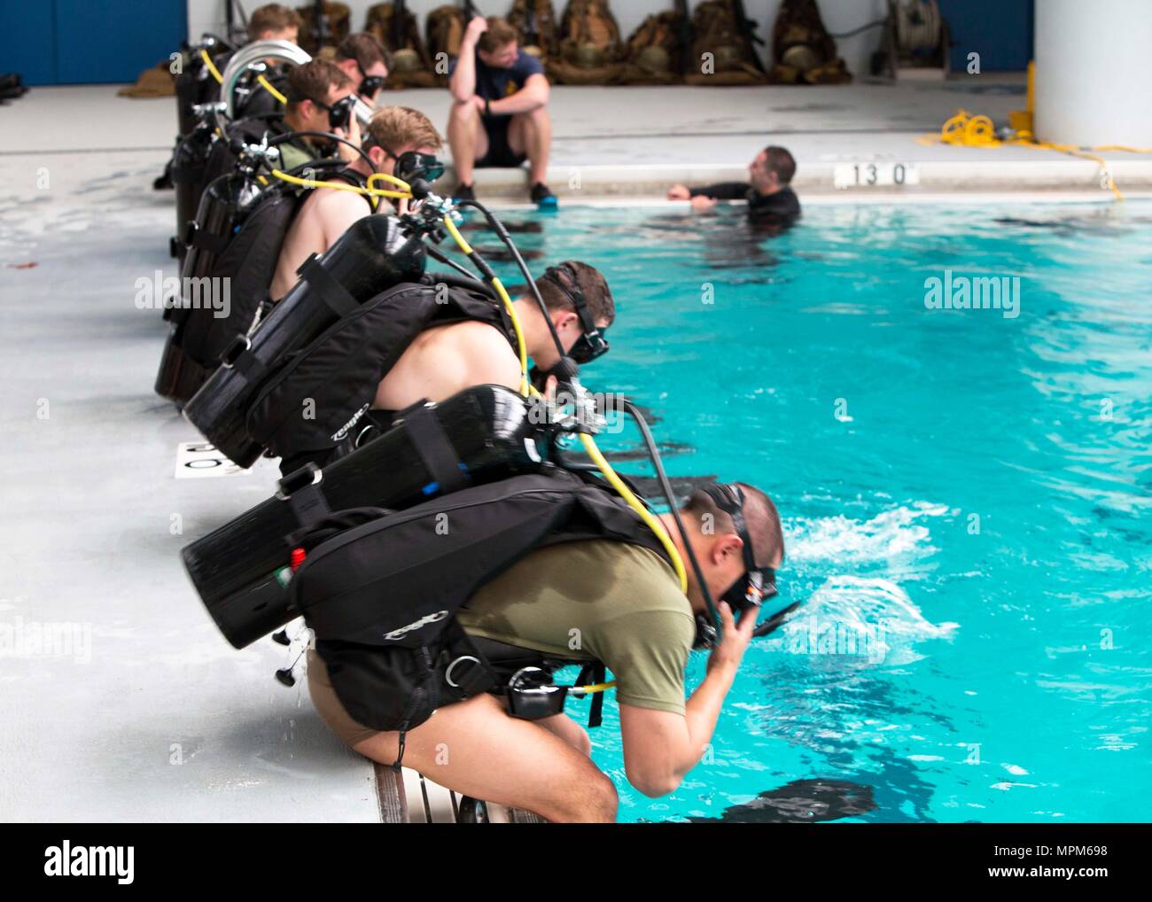 Marines dive into the pool during a battalion training event at Camp Lejeune, N.C., March 23, 2017. The self-contained underwater breathing apparatus provides Marines with deep-water diving capabilities essential for conducting real-world scenarios. The Marines are with 2nd Reconnaissance Battalion, 2nd Marine Division. (U.S. Marine Corps photo by Sgt. Clemente C. Garcia) Stock Photo