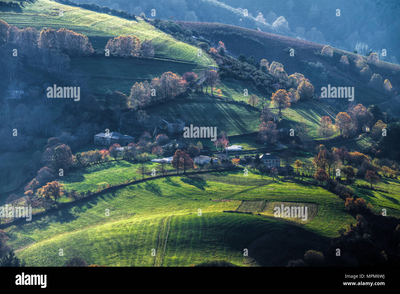 Typical Galician rural landscape, with stone houses, pastures and deciduous forests, in Becerreá, Lugo, Galicia Stock Photo