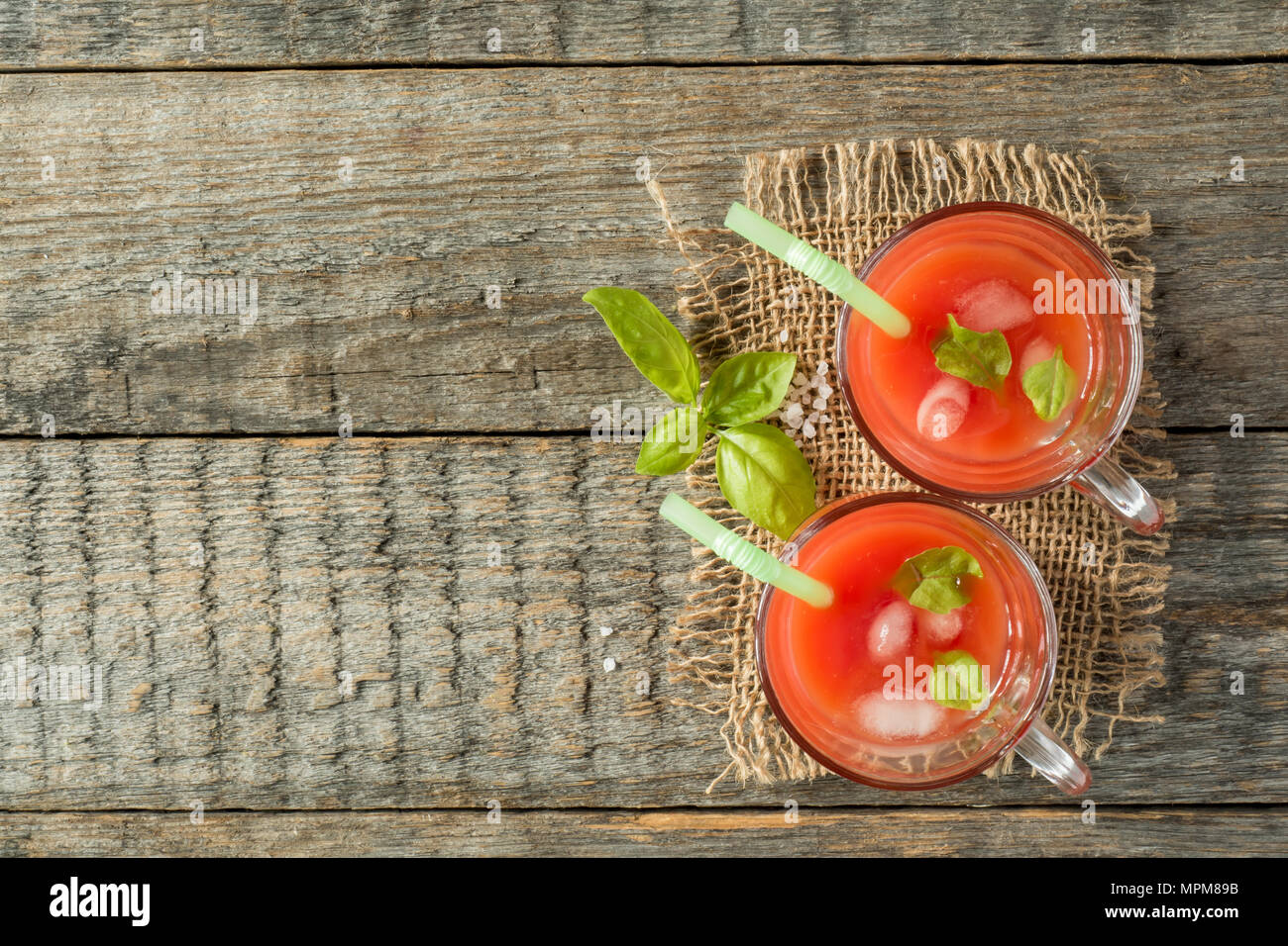 Red cocktail with tomato juice, Basil and salt, selective focus. Stock Photo