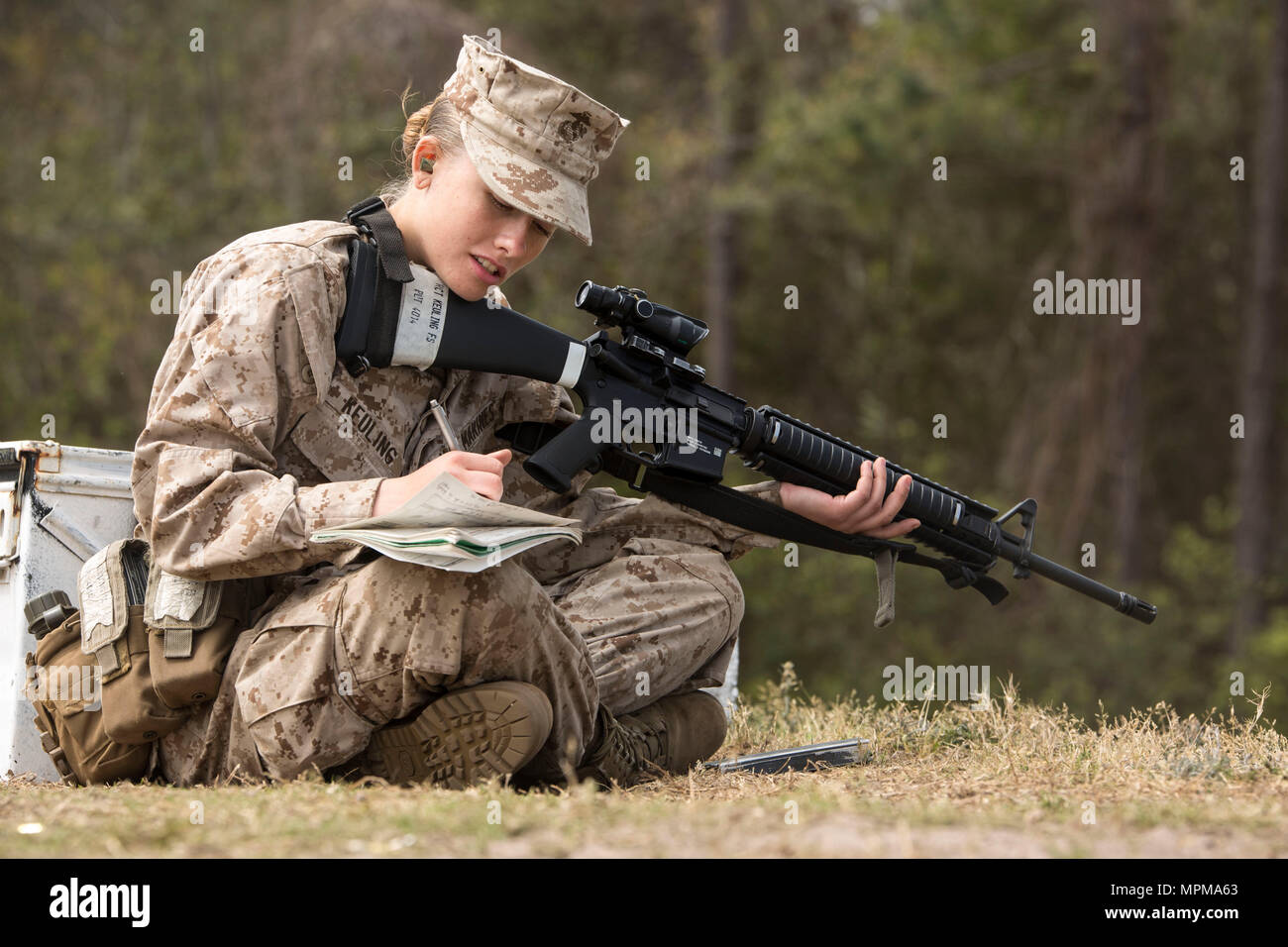 Rct. Fantasia S. Keuling, Platoon 4014, Papa Company, 4th Recruit Training Battalion, marks her shot during marksmanship training March 23, 2017, on Parris Island, S.C. Recruits keep a careful log of their shot groups in order to track and improve their shooting abilities. Keuling, 18, from Olivia, N.C., is scheduled to graduate April 28, 2017. Parris Island has been the site of Marine Corps recruit training since Nov. 1, 1915. Today, approximately 19,000 recruits come to Parris Island annually for the chance to become United States Marines by enduring 12 weeks of rigorous, transformative trai Stock Photo