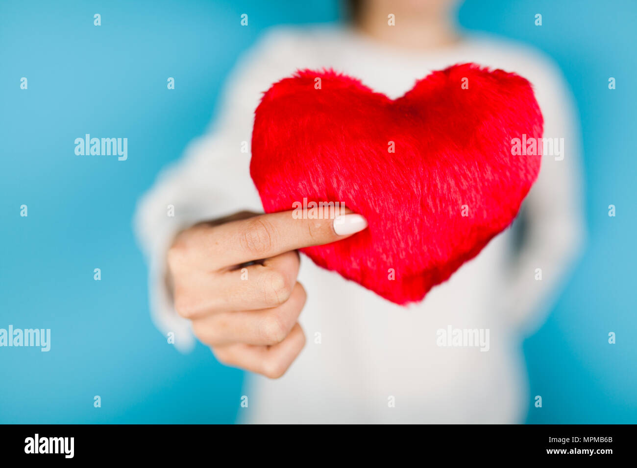Female hands holding a red heart Stock Photo - Alamy