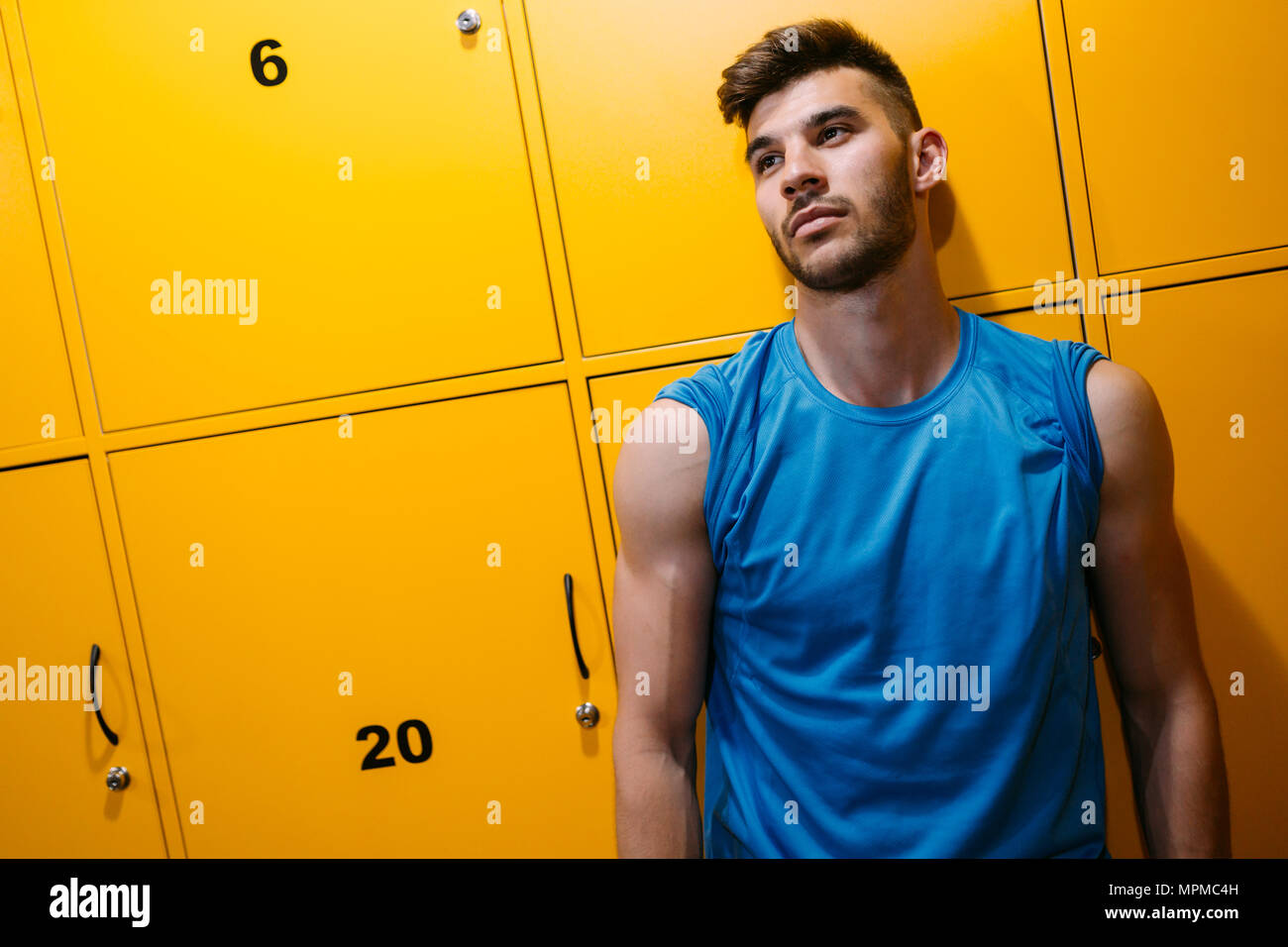 Portrait of young handsome man in locker room Stock Photo