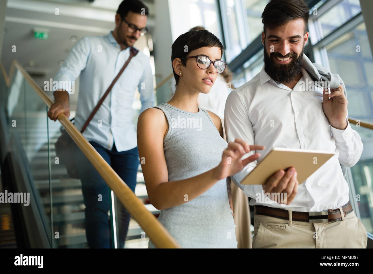 Group of young perspective businesspeople having discussion Stock Photo ...