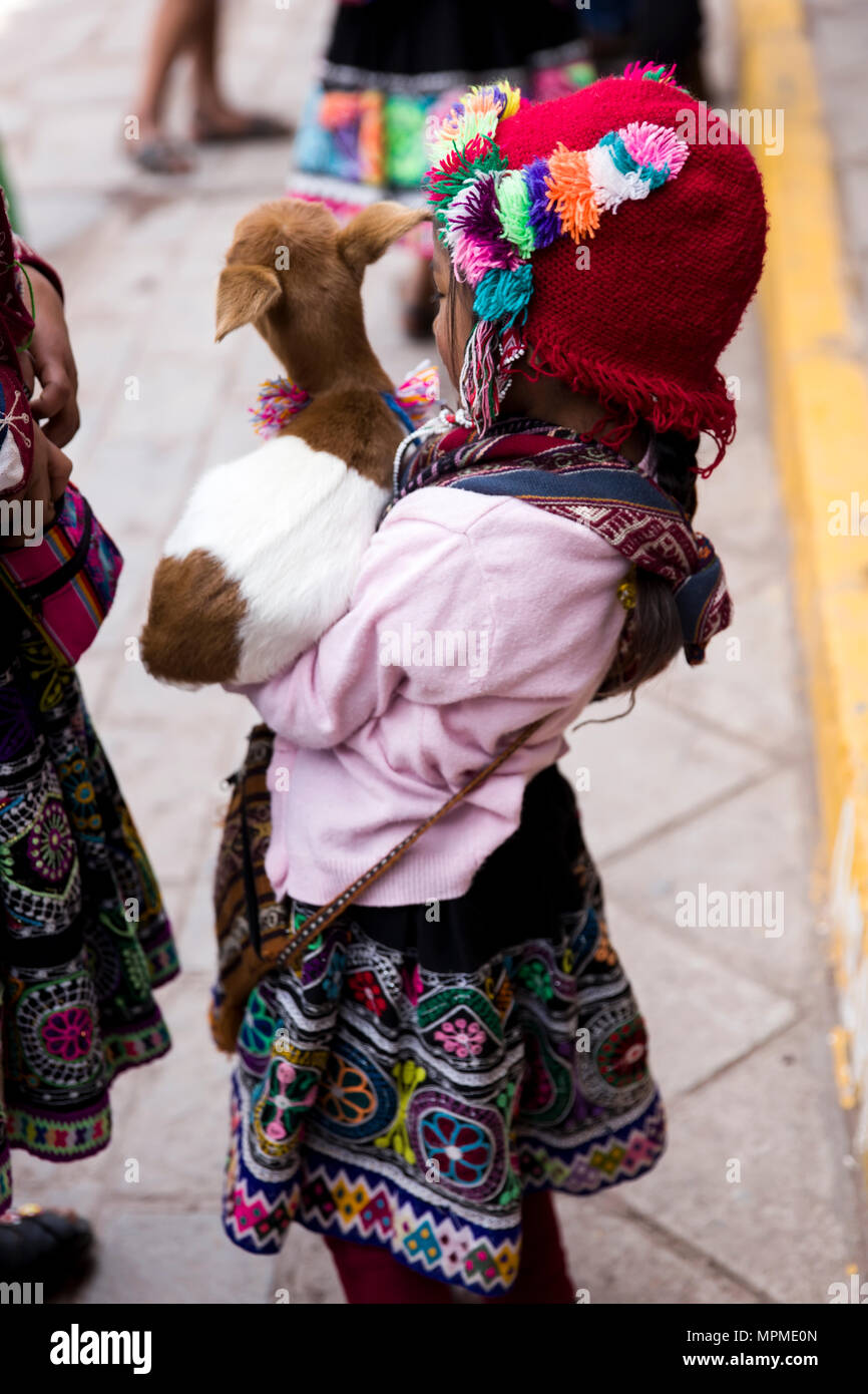 CUSCO, PERU - DECEMBER 31, 2017: Unidentified girl on the street of Cusco, Peru. Almost 29% of Cusco population have less than 14 years. Stock Photo